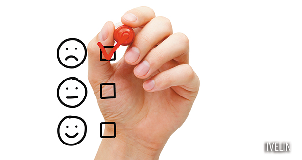 Hand putting check mark with red marker on poor customer service evaluation form.