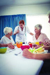 Pensioners at lunch in the retirement house