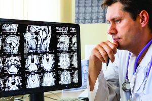 Doctor in hospital looking at ct scan