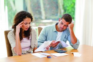 Young couple calculating their domestic bills at home