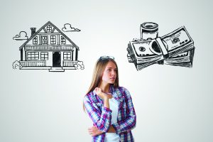 Attractive caucasian girl on grey background with house and money sketch. Real estate, mortgage and housing concept