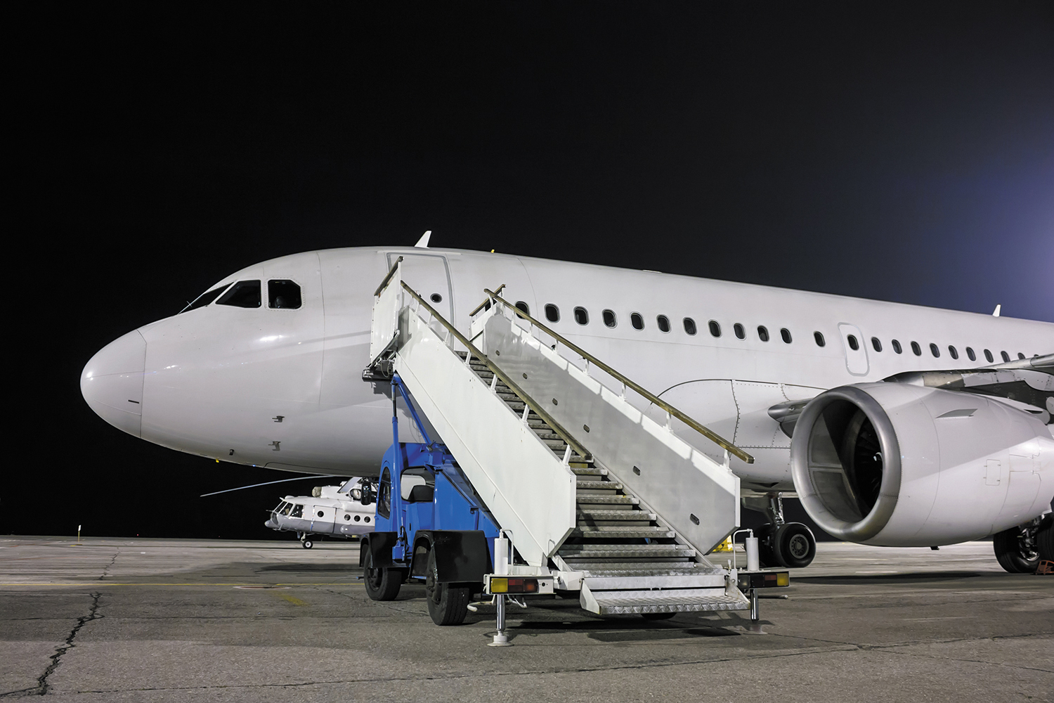 Airplane and passenger boarding steps vehicle at the night airpo